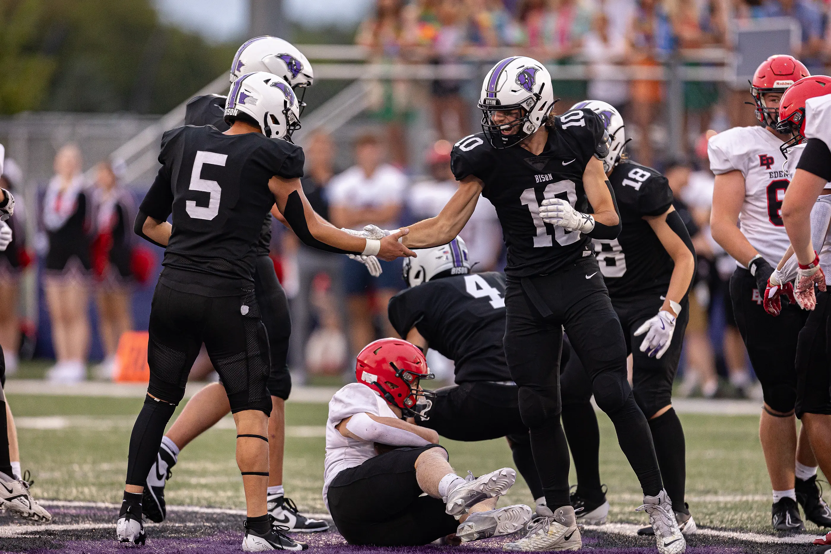 Defensive players celebrating a tackle